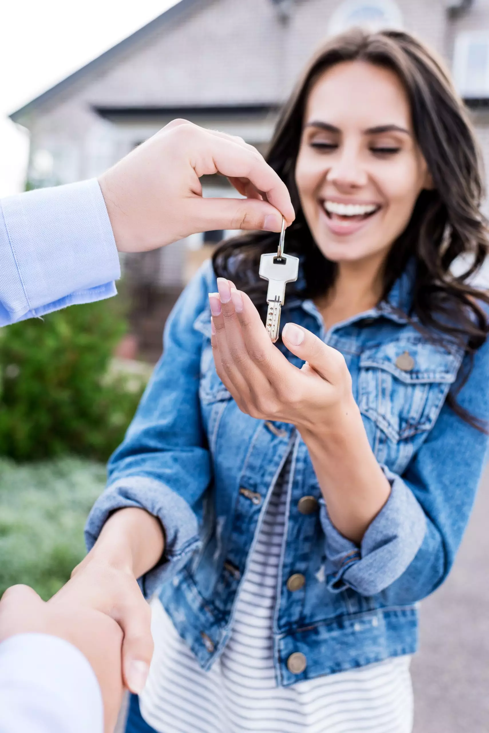 Close-up shot of woman buying new house and shaking hands with realtor